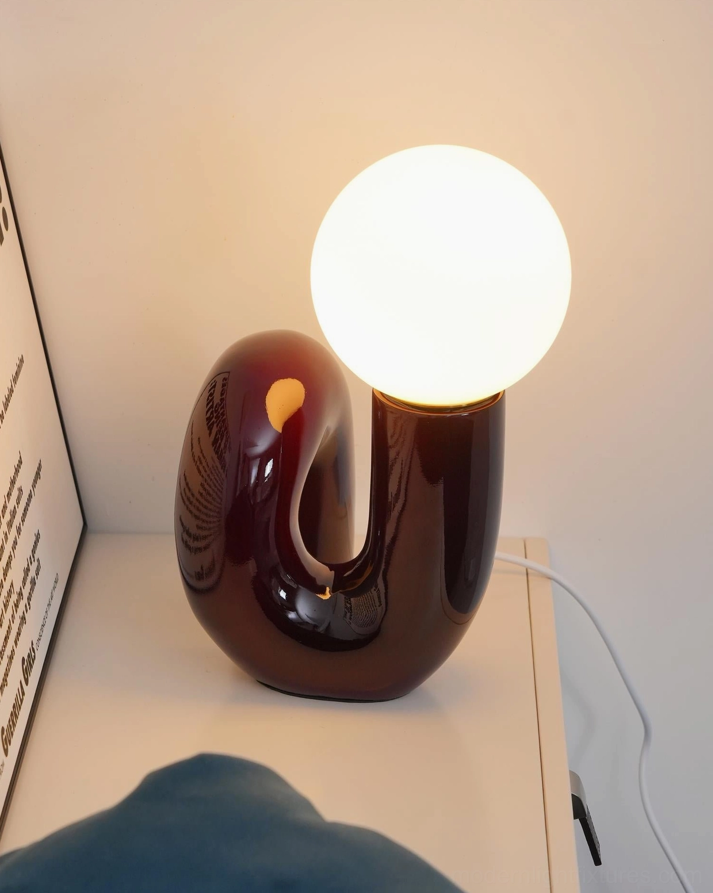 N-shape glass table lamp front view showcasing geometric and organic design balance