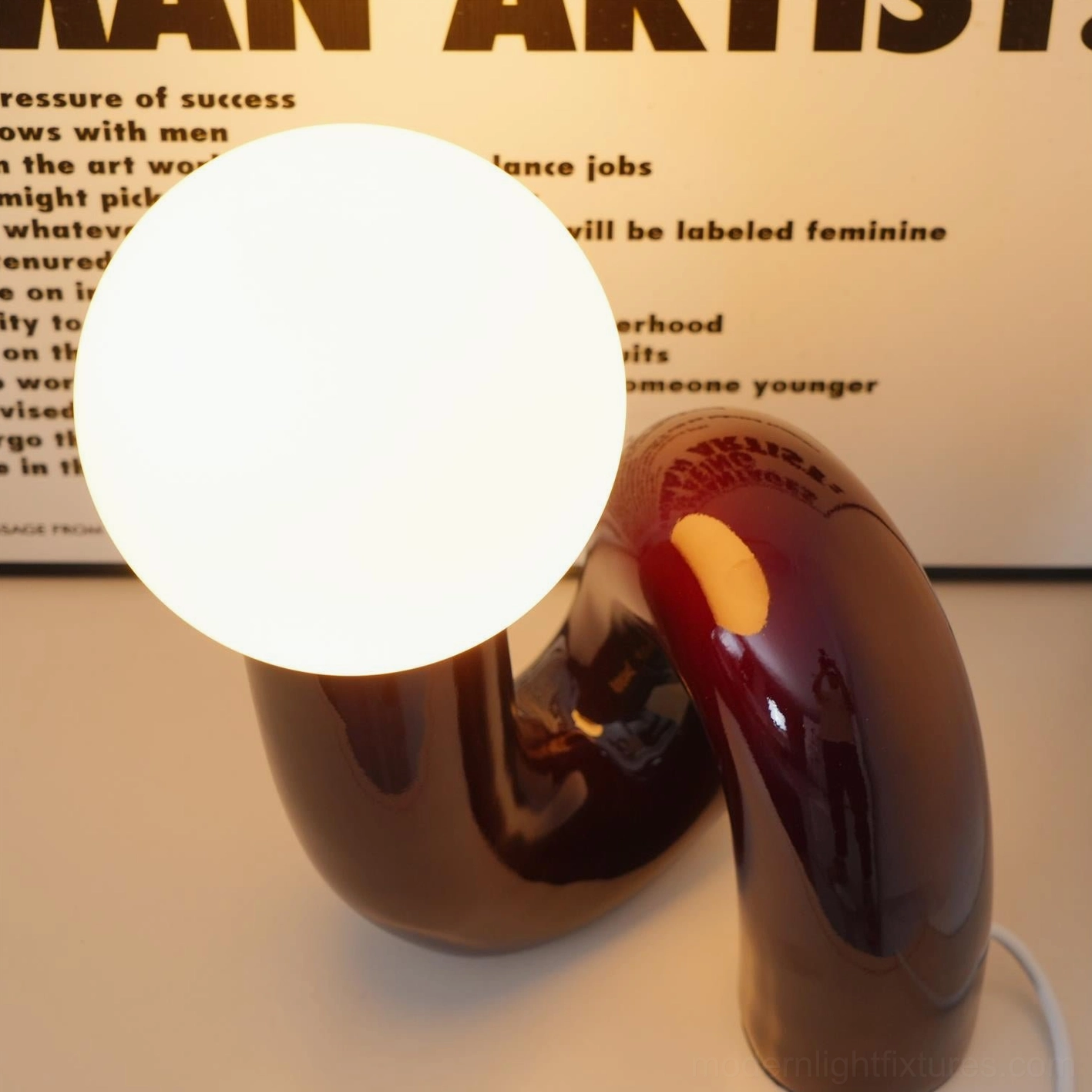 Contemporary N-shape glass table lamp bottom view showing base structure and stability design
