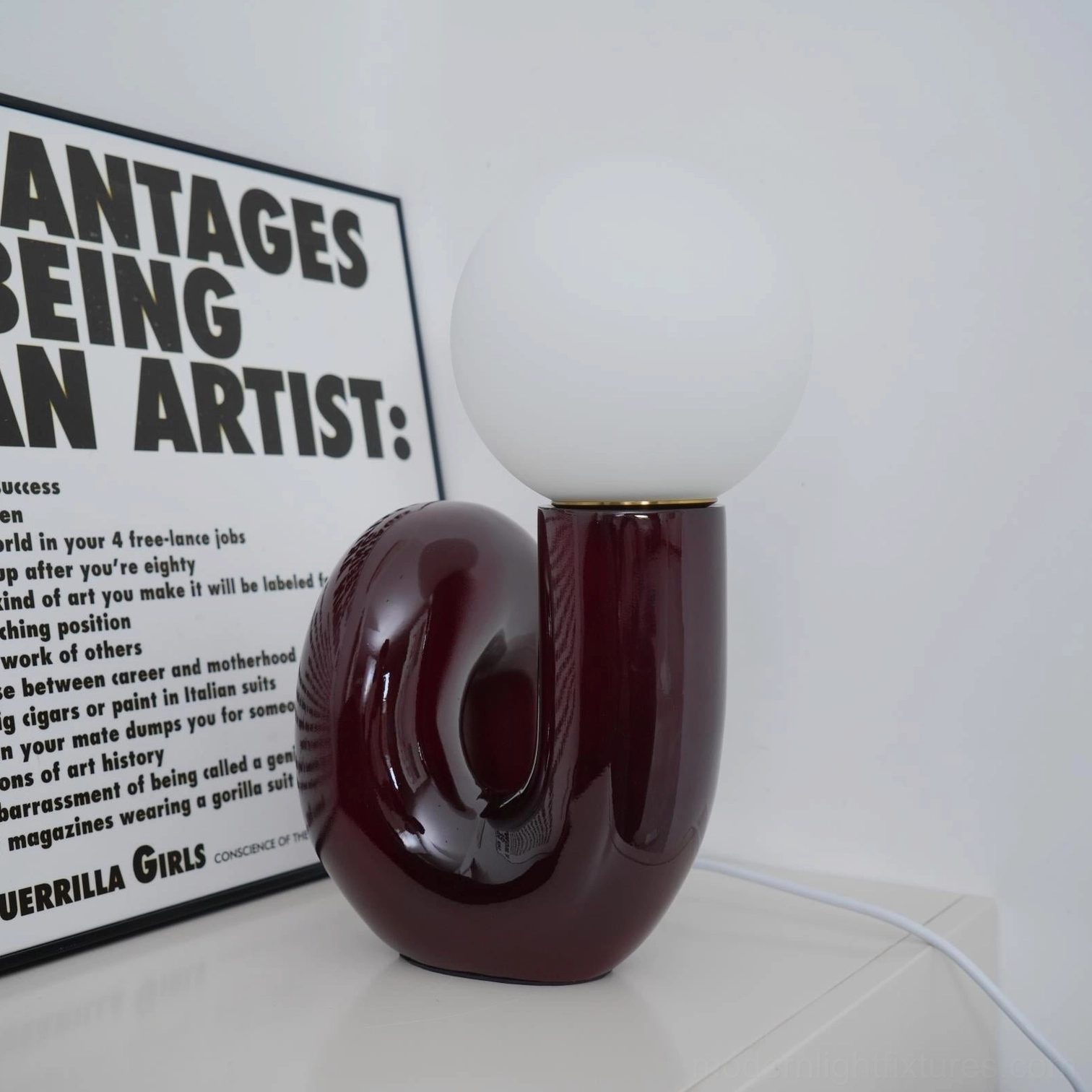 N-shape glass table lamp close-up detail of ceramic base craftsmanship and finish quality