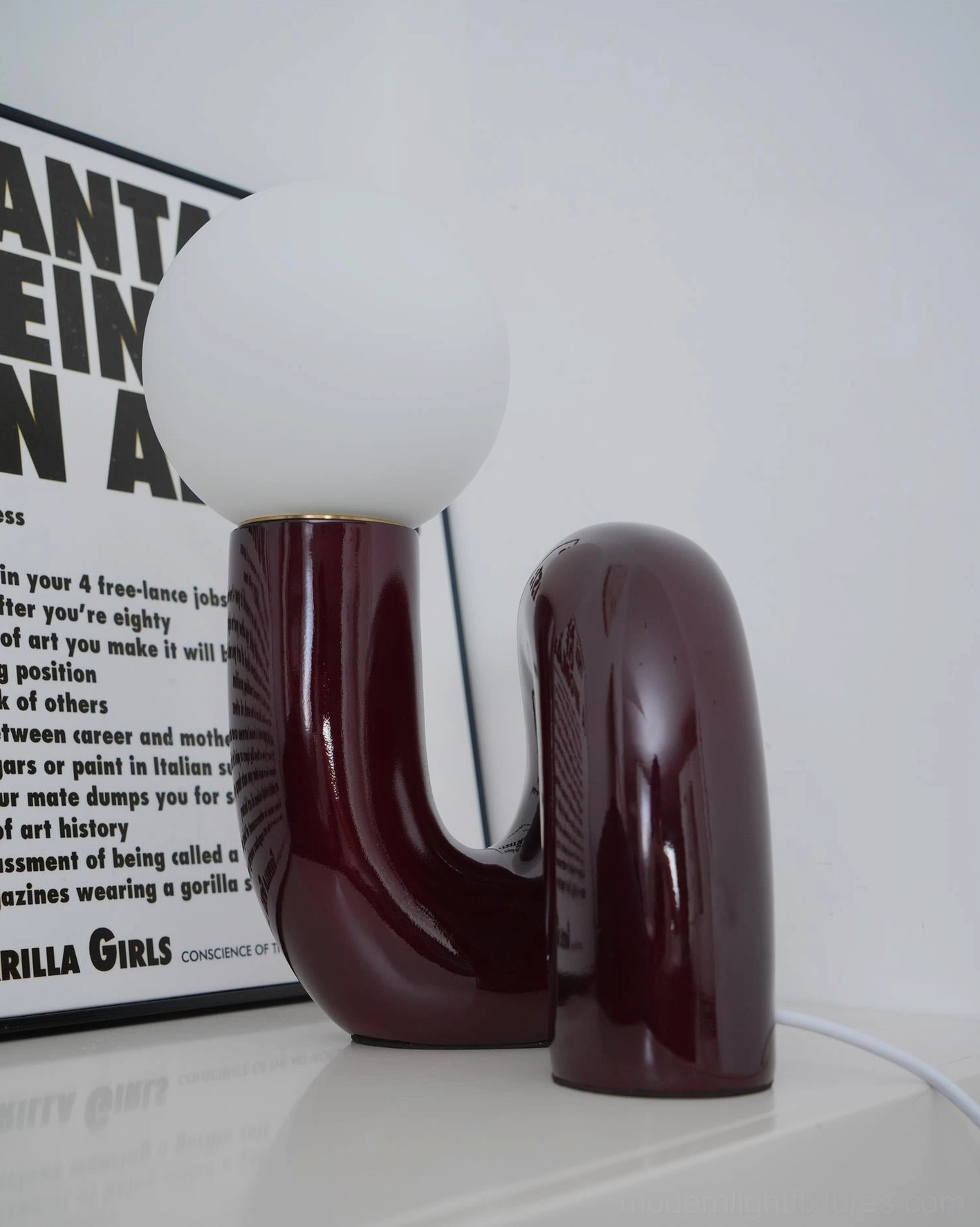 Modern N-shape table lamp glass shade and ceramic connection point architectural detail