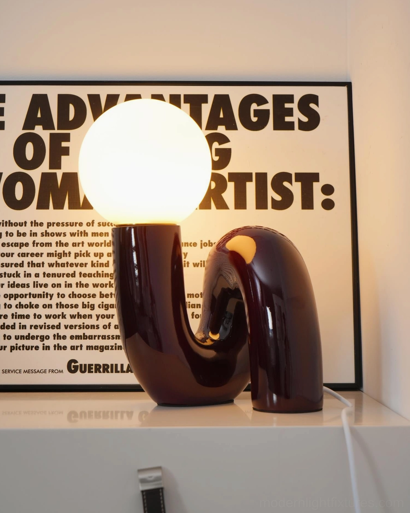 N-shape contemporary glass lamp with illuminated frosted shade creating warm atmospheric glow