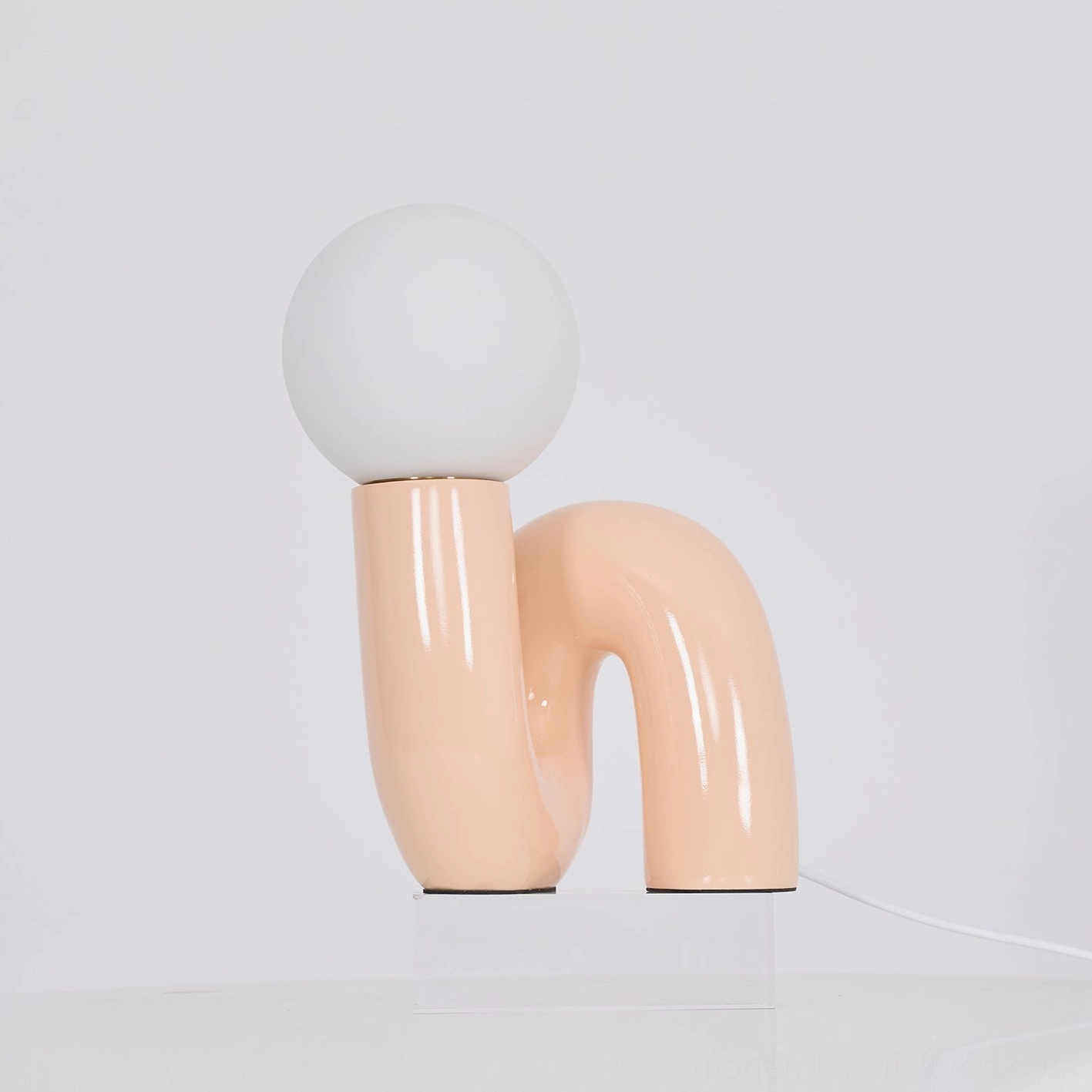 N-shape contemporary table lamp styled in mid-century modern interior design setting