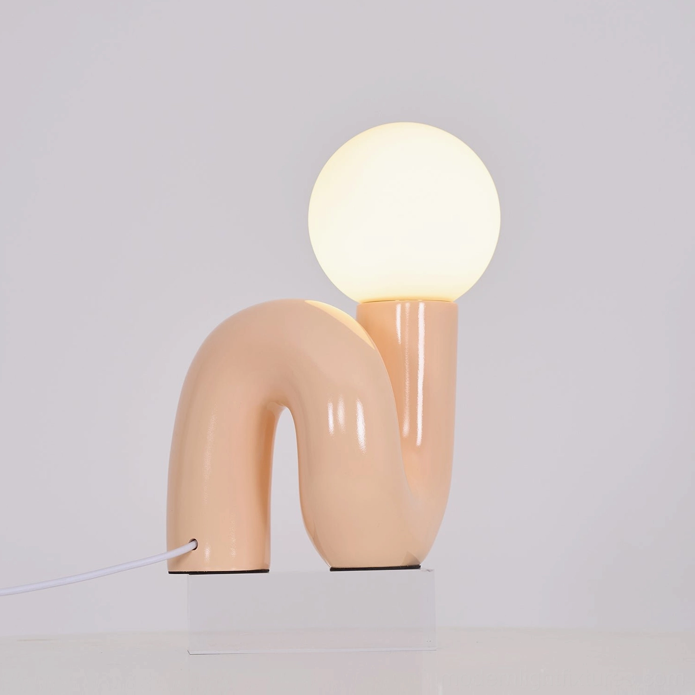 Modern N-shape glass lamp as accent piece in transitional style home interior design