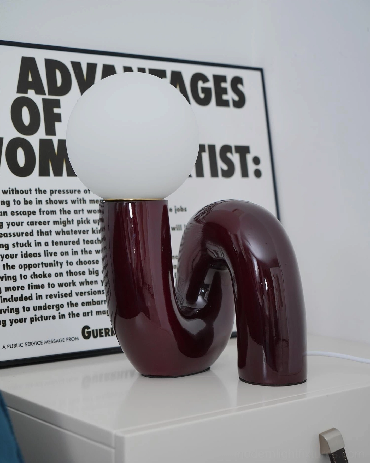 N-shape modern table lamp with curved ceramic base and frosted glass shade detail view