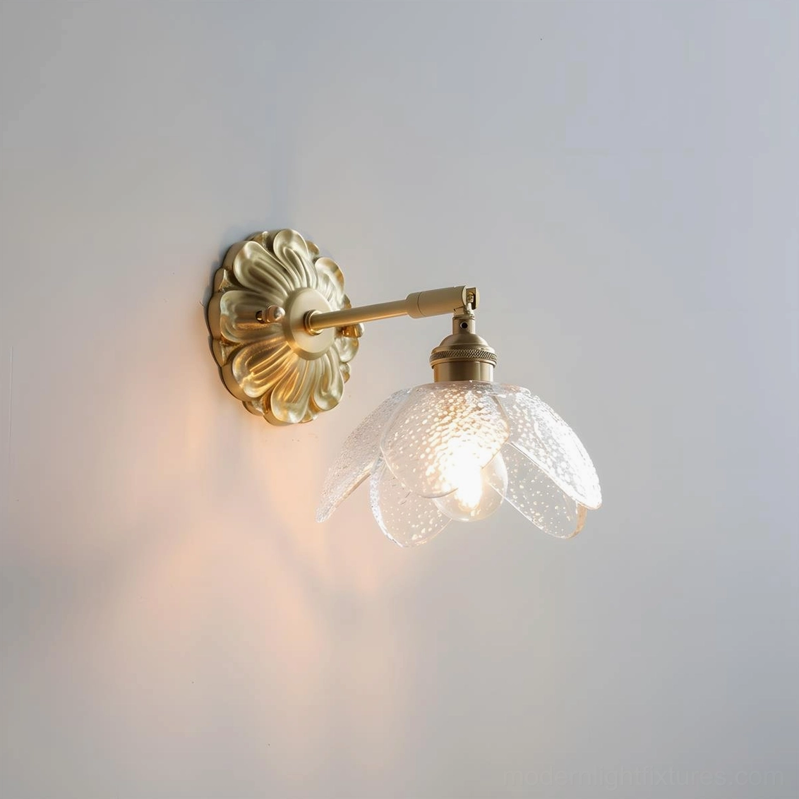 Nacre Petal Wall Sconce with clear glass shade, brass base, product front view studio lighting