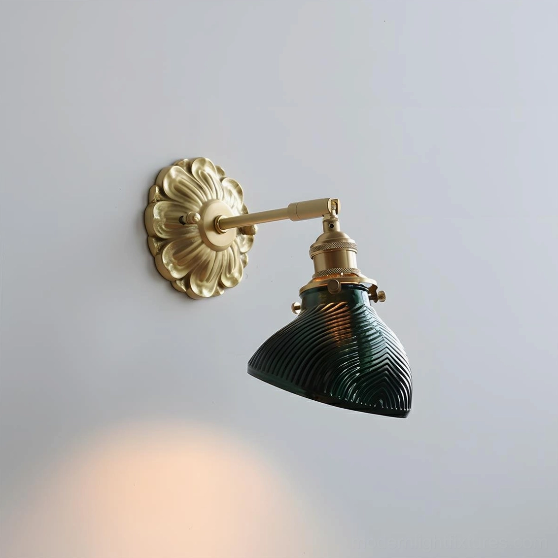 Nacre Petal Wall Sconce with green glass shade, brass hardware, close-up front view illuminated