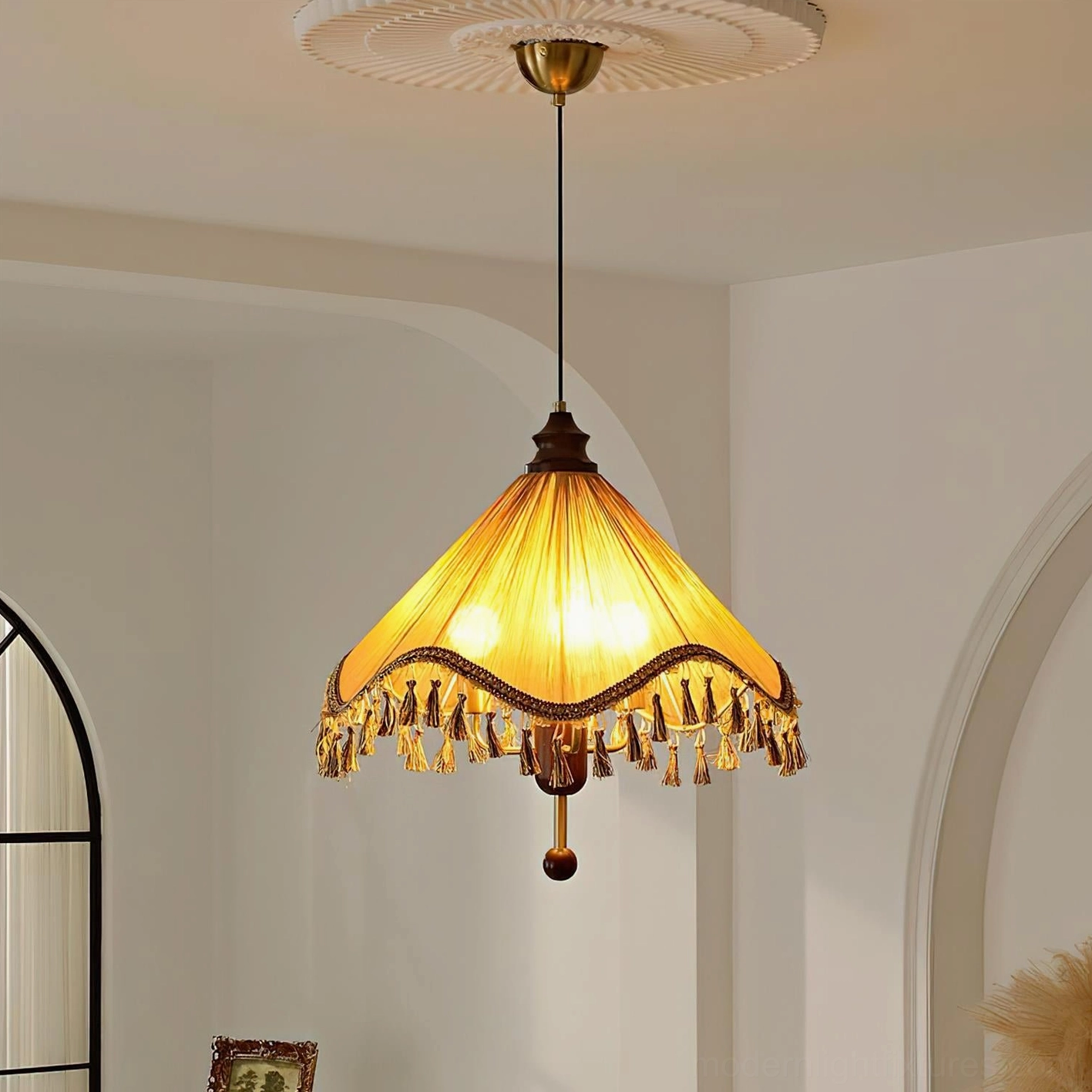 Nadia pleated fabric pendant light with decorative tassel trim and ornate finial, close-up detail showing craftsmanship and design elements