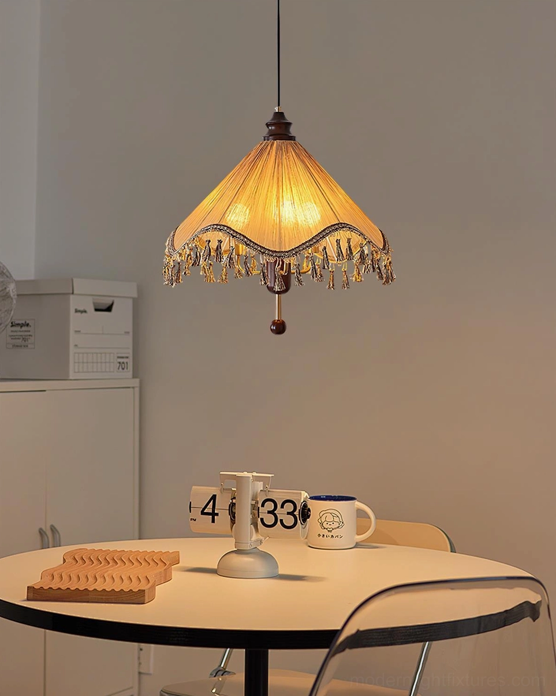 Nadia tassel pendant lamp creating warm ambient glow, suitable for dining room and living space atmospheric lighting design