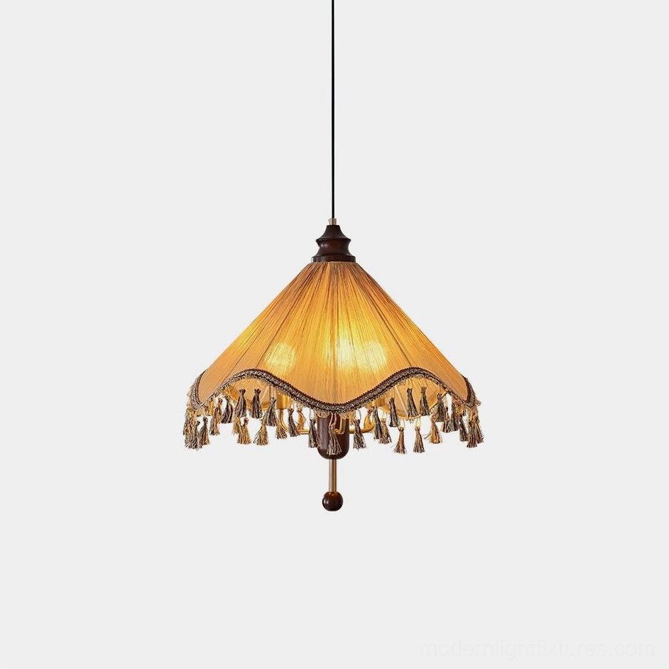 Nadia pleated fabric pendant light with tassel fringe in khaki beige, shown from overhead view against minimalist white studio background
