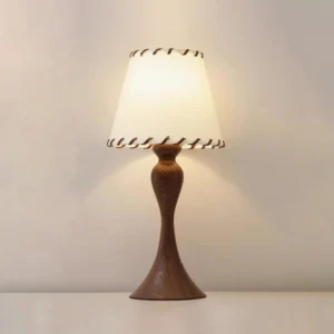 Nala table lamp illuminated showing warm light diffusion through textured fabric shade