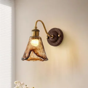 Amber wall sconce illuminated on residential wall with warm light and window blinds creating ambient lighting atmosphere