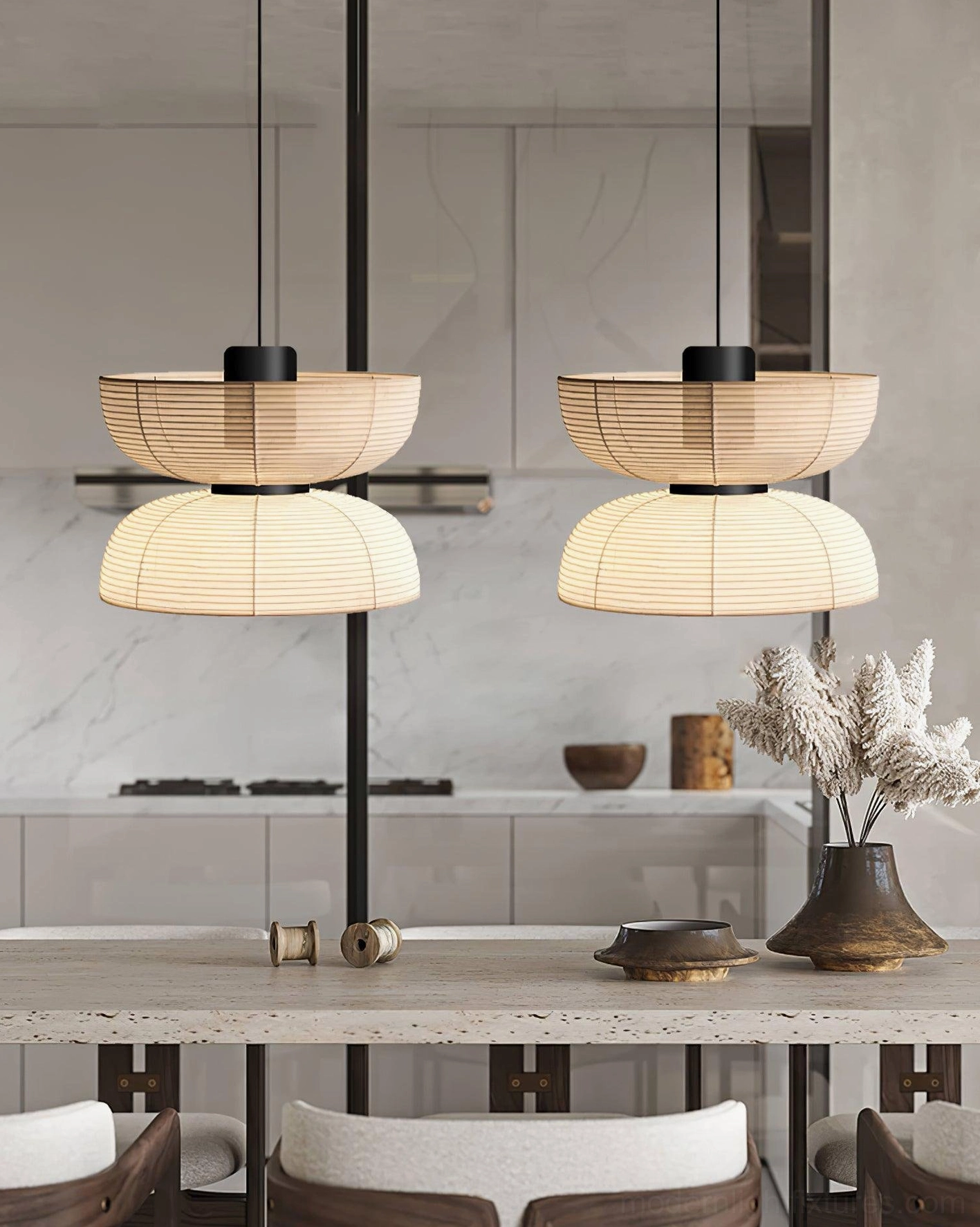 Pair of matching Nando pendant lamps in modern dining area, warm beige woven shade, side perspective