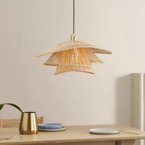 Natural bamboo rattan pendant lamp displayed above dining table with brass fixture detail