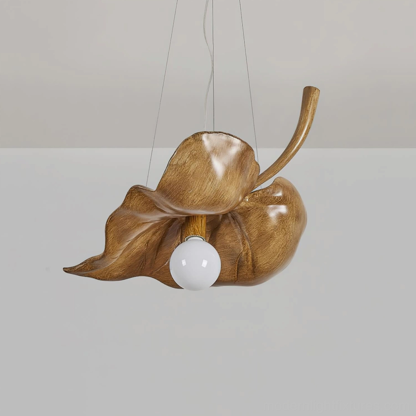 Maple leaf pendant light with natural wood finish and exposed mounting hardware, studio photography