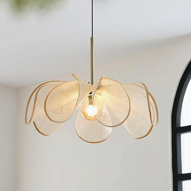 Natural jute petal pendant lamp installed in minimalist home with arched black window, warm brass suspension rod and ambient lighting