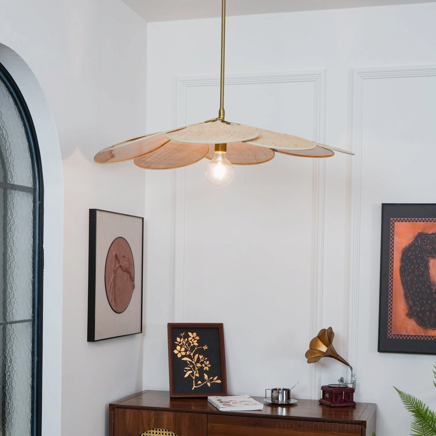 Natural rattan pendant light creating cozy ambiance in farmhouse bohemian styled living space