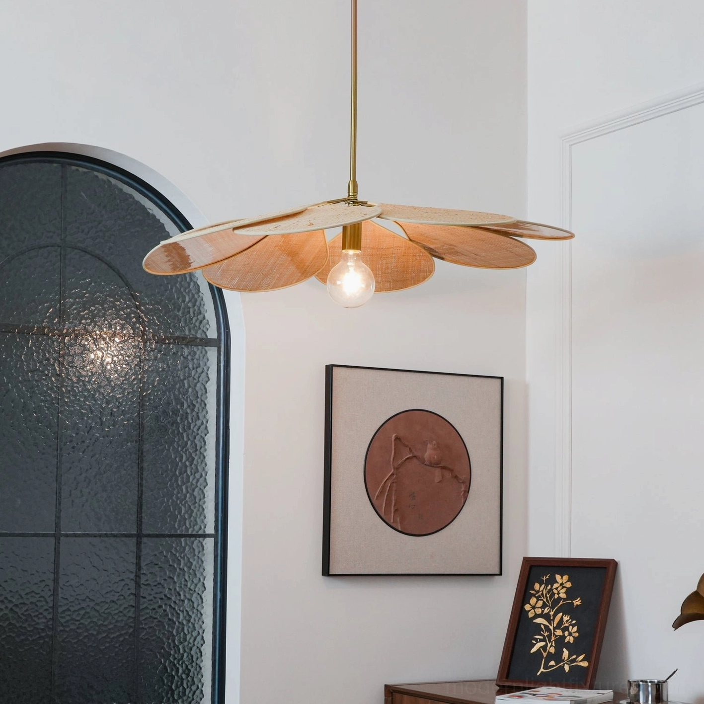 Natural woven rattan pendant light casting organic shadow patterns on ceiling and walls