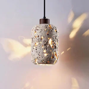 Three-quarter view of textured travertine pendant lamp casting warm spotted light patterns with brown metal fixture