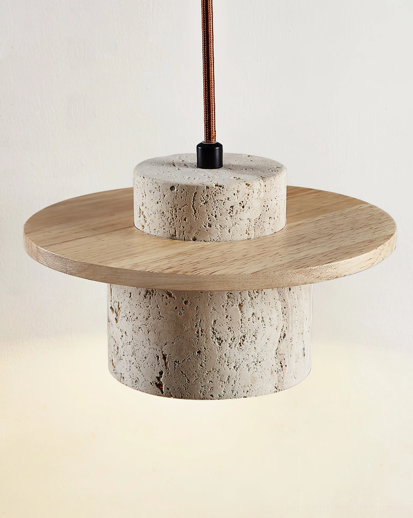 Natural stone pendant lamp with light wood disc, overhead close-up showing porous travertine cylinder and dual-light emission
