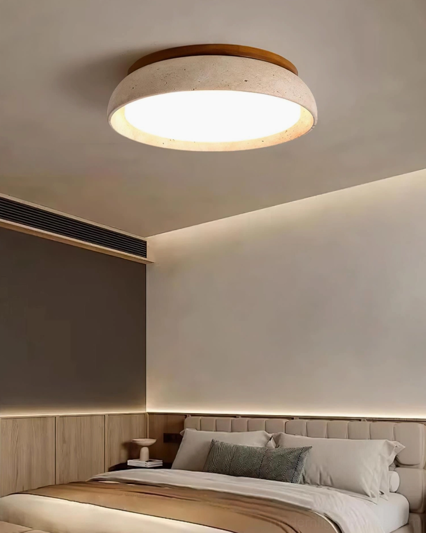 Natural travertine flush mount ceiling light in large bedroom interior with soft ambient glow