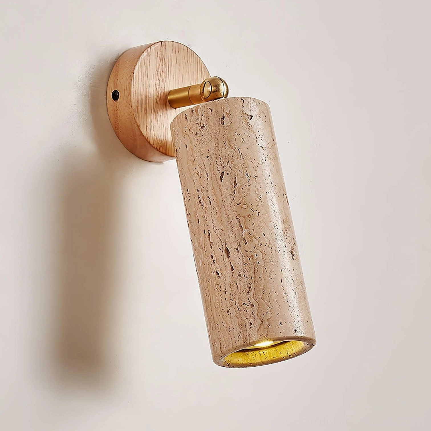 Mireille travertine sconce with light wood backplate and brass hardware on white wall showcase