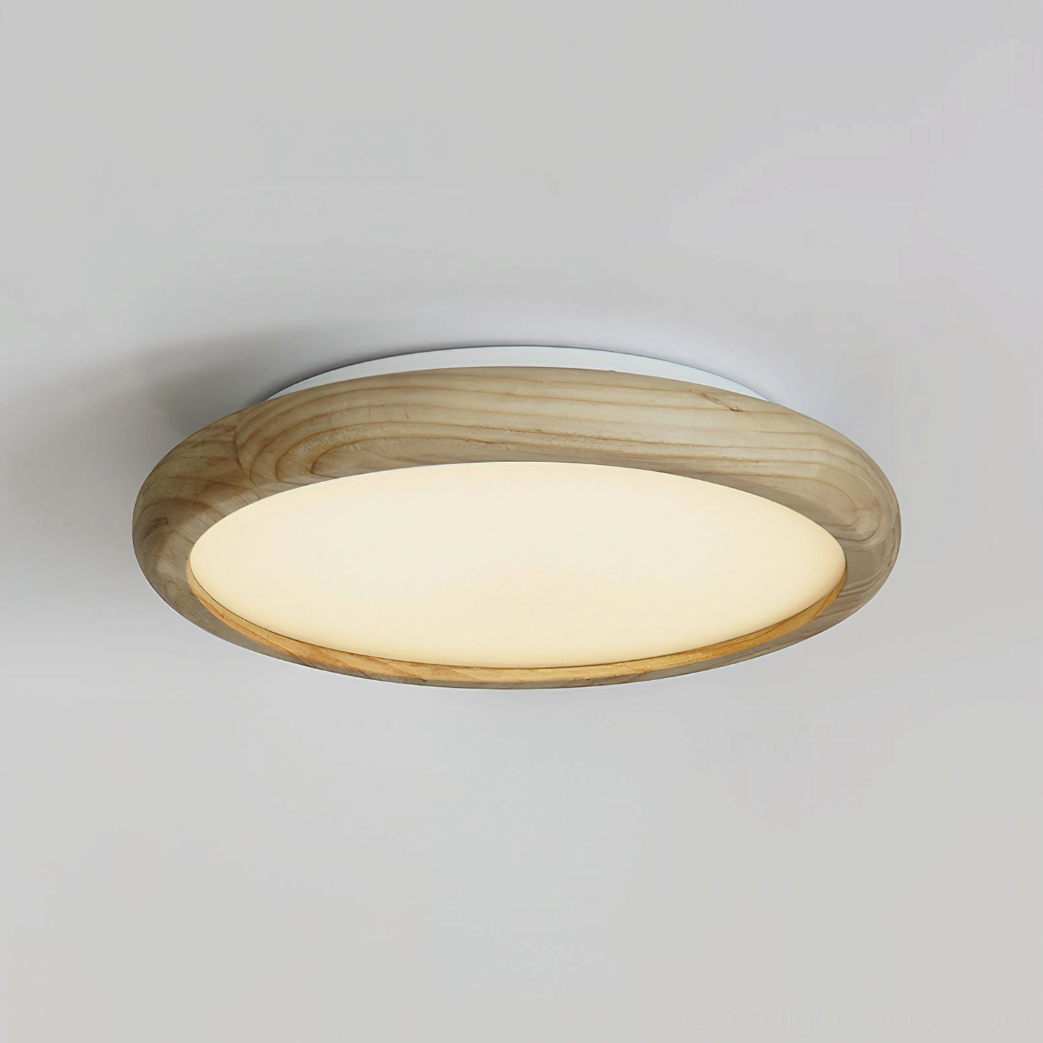 Natural wood frame flush mount ceiling light with botanical relief detailing, front close-up studio shot