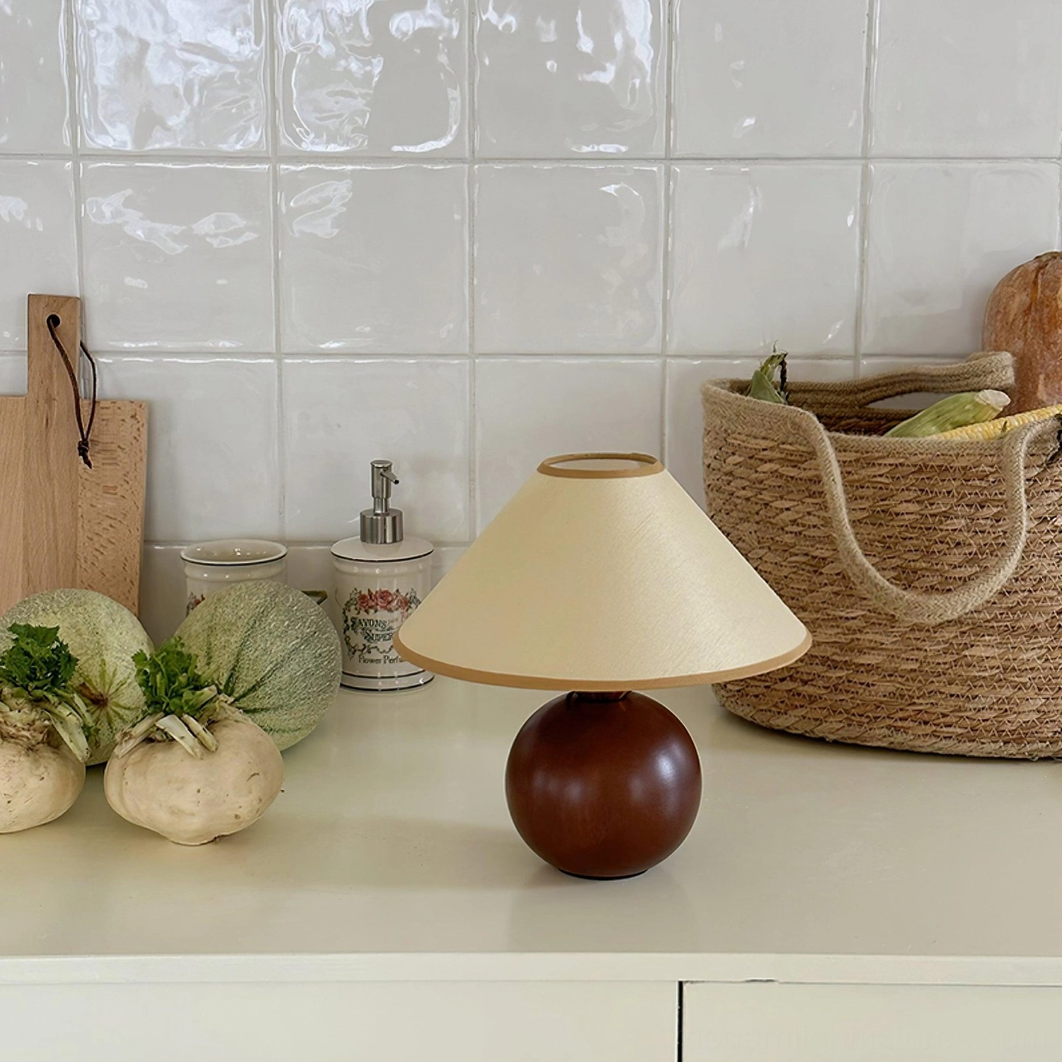 Natural wood table lamp with beige hemp shade, warm glow in living space ambiance