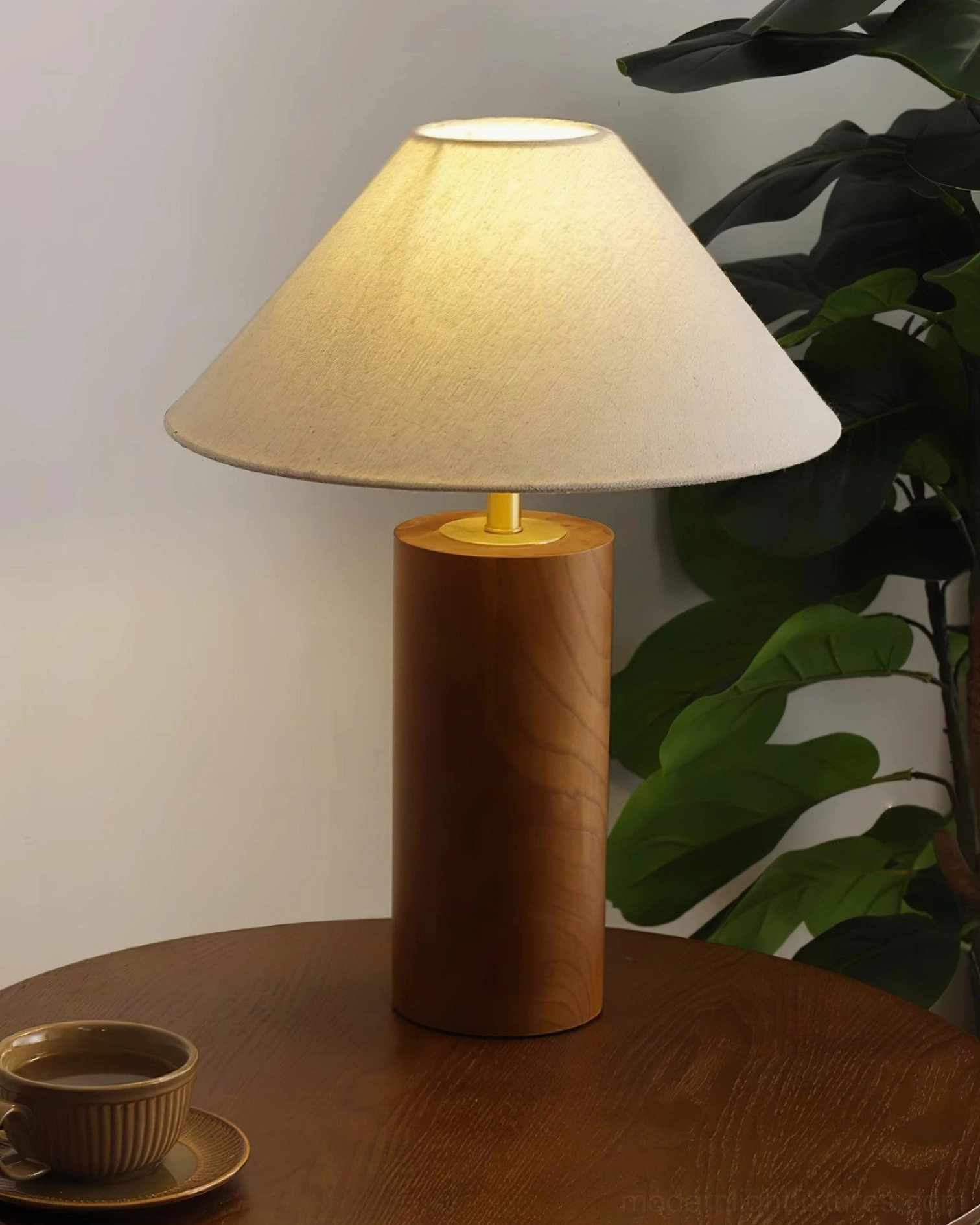 Table lamp in natural wood color creating warm glow with soft ambient light diffusion