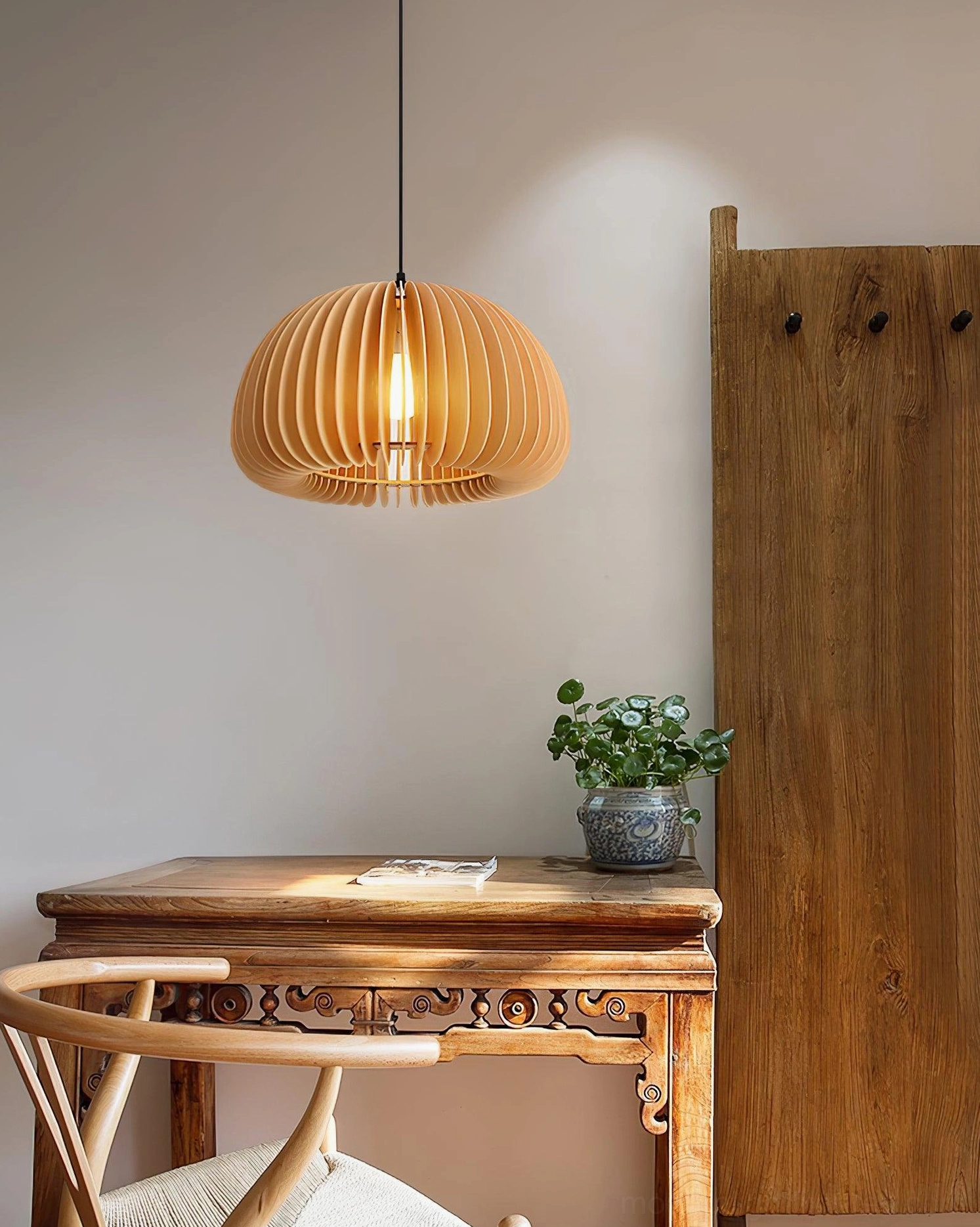 Pumpkin-shaped wood pendant lamp with warm light and natural wood grain texture