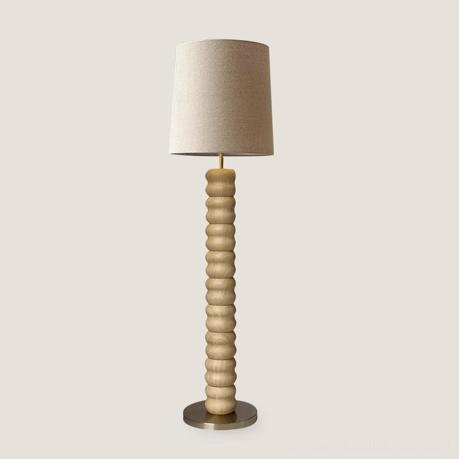 Natural wood stacked floor lamp with white linen shade creating soft diffused illumination