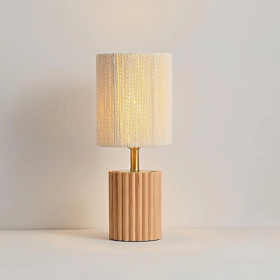 Natural wood table lamp with finely grooved base and beige pleated fabric shade on white background