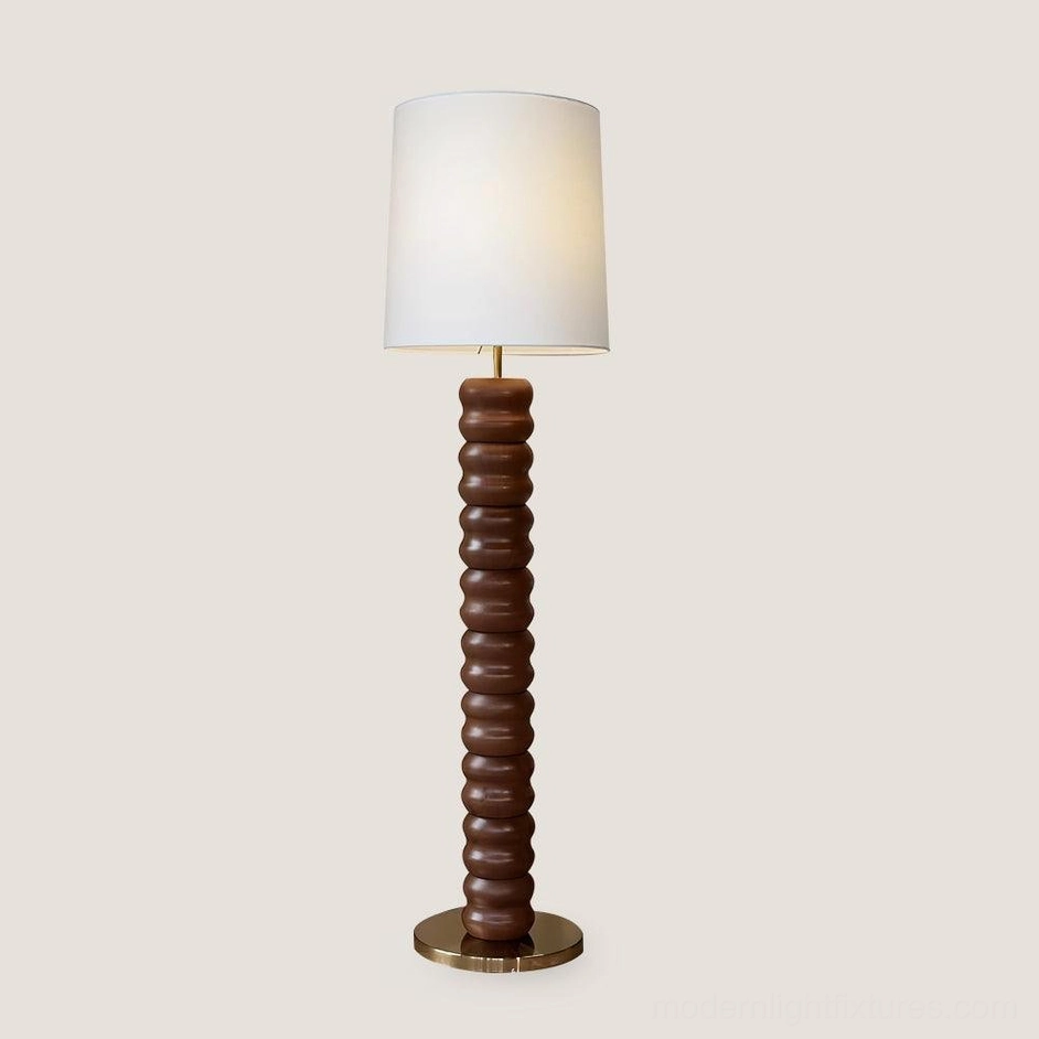 Natural wood tone stacked floor lamp with fabric shade and metal hardware in contemporary home