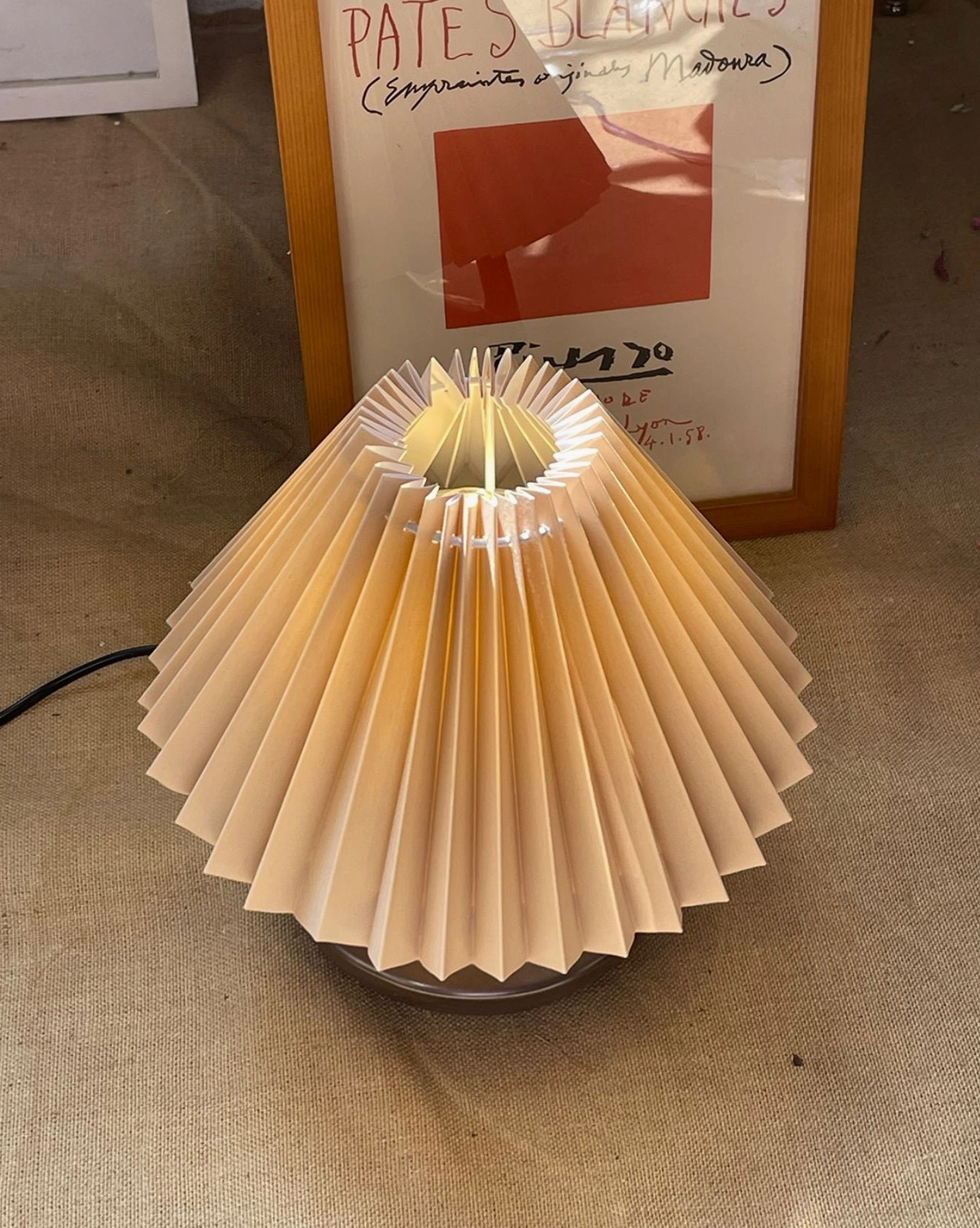 Navia Pleated Table Lamp overhead view with unlit pleated shade and simple round ceramic base design