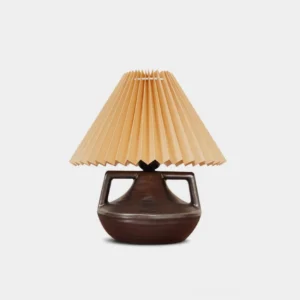 Navia Pleated Table Lamp with rust ceramic base and cream fabric pleated shade, front studio view