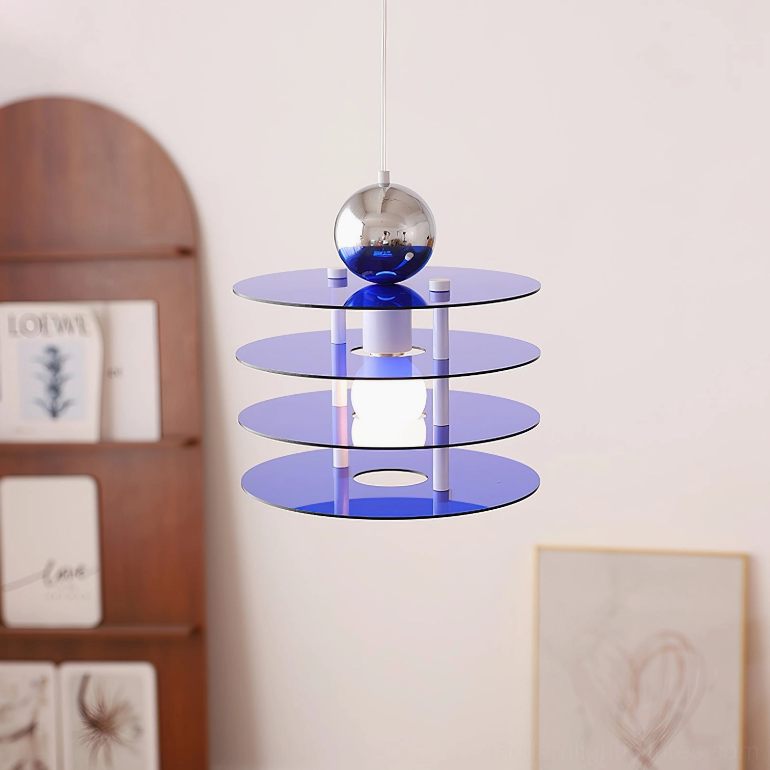 Navy blue layered pendant lamp with silver finial and white support structure