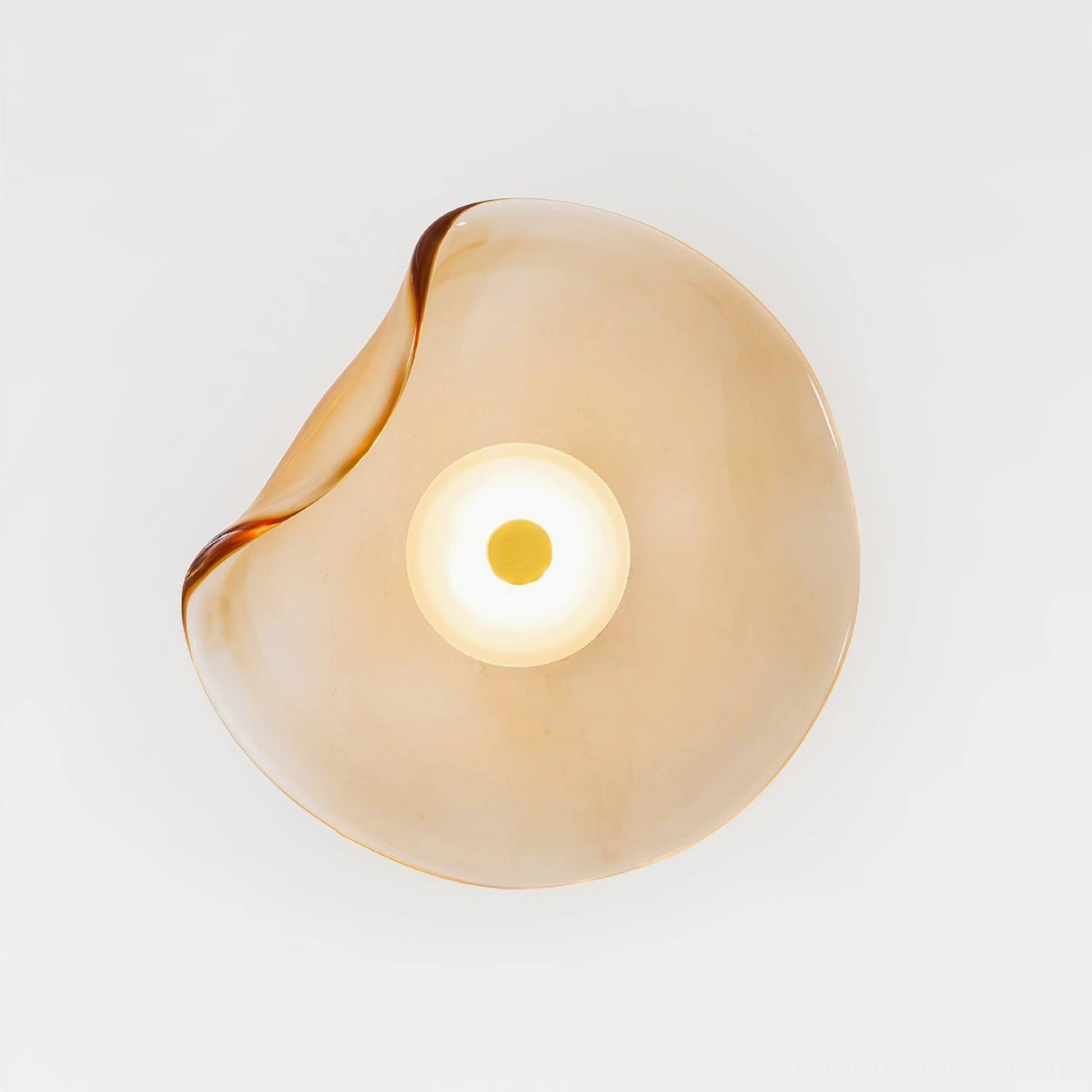 Nebulae wall sconce with light amber glass - overhead studio product shot with warm beige tone
