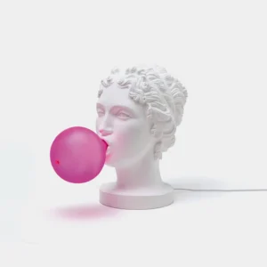 Neoclassical Greek bust table lamp with glowing hot pink bubble shade, front view on white studio background, sculptural resin design
