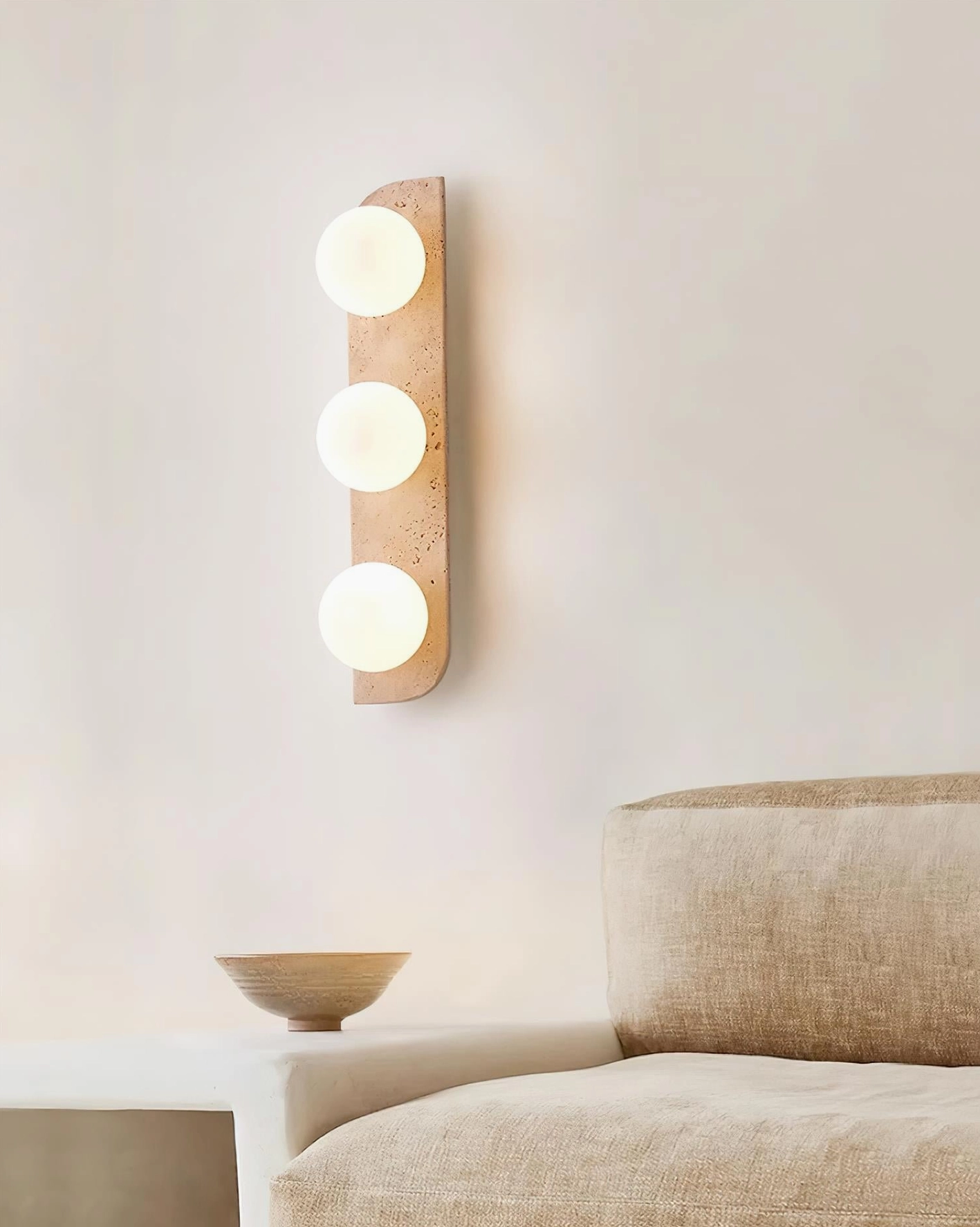 Neptune beige travertine wall sconce 2-light configuration mounted on warm neutral wall background
