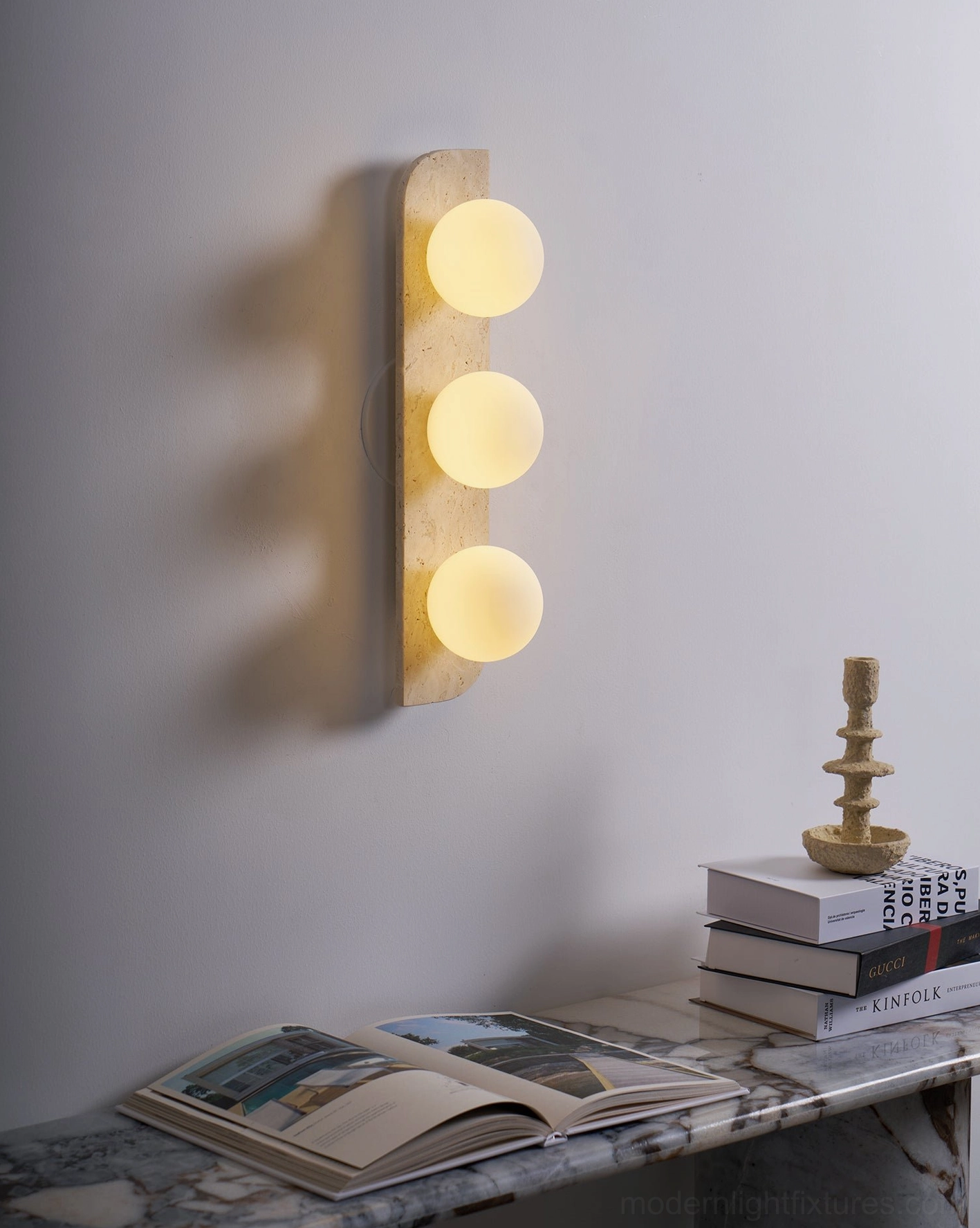 Neptune travertine wall sconce paired configuration bedroom mirror vanity balanced architectural arrangement