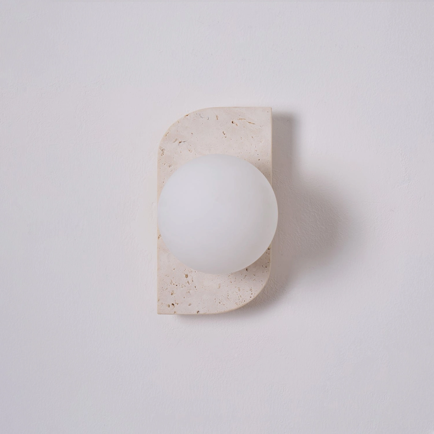 Neptune travertine wall sconce wabi-sabi japandi design philosophy imperfection authentic material