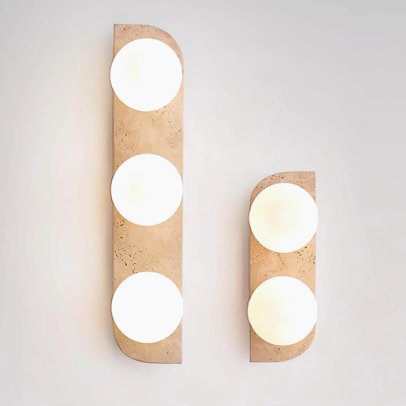 Neptune 3-light and 2-light travertine wall sconces angled view showing frosted glass and stone texture detail