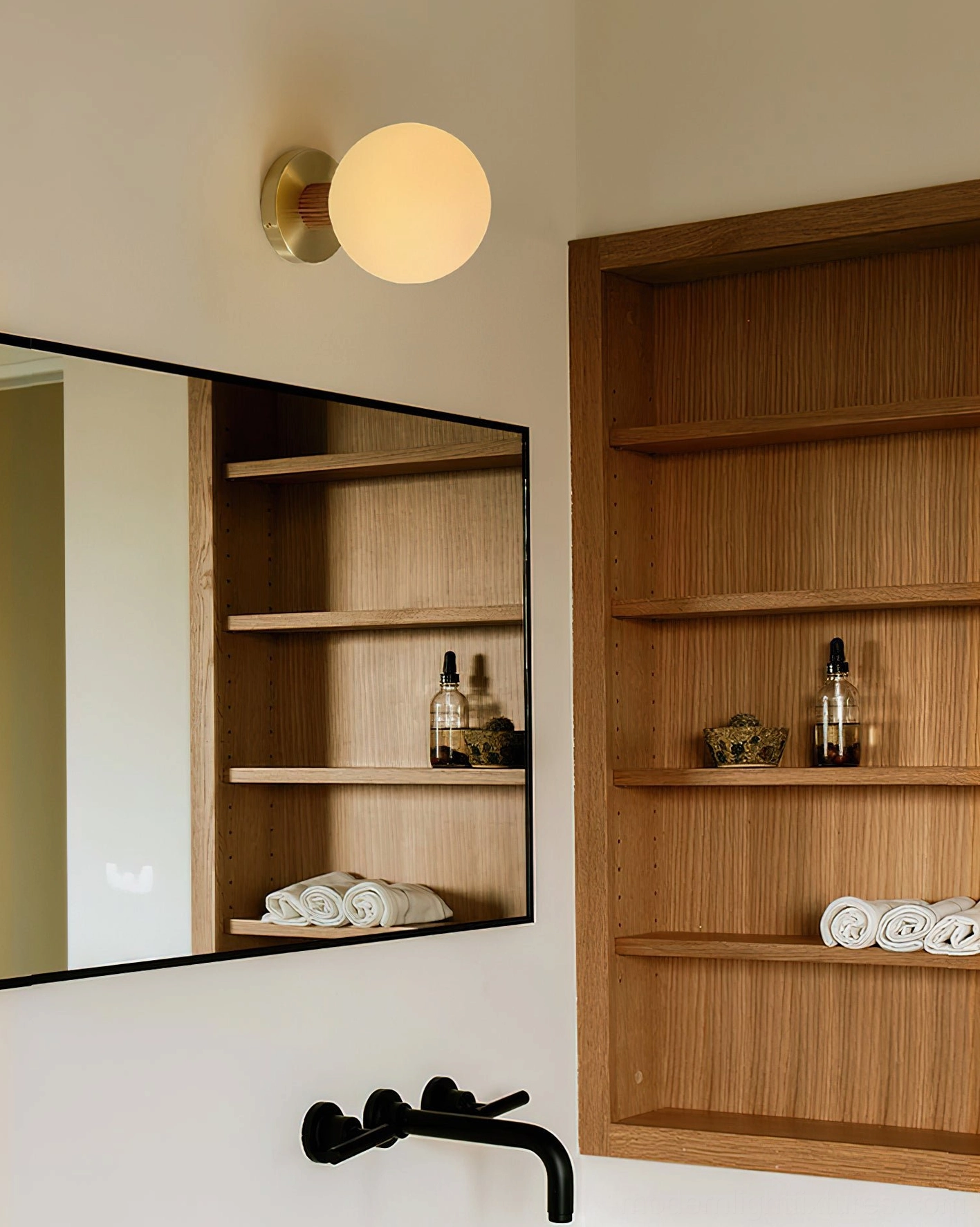 Neroma frosted glass ceiling light in bathroom vanity area with brass mount and spherical shade
