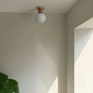 Modern Neroma semi-flush frosted globe ceiling lamp installed in residential corner room, warm ambient lighting
