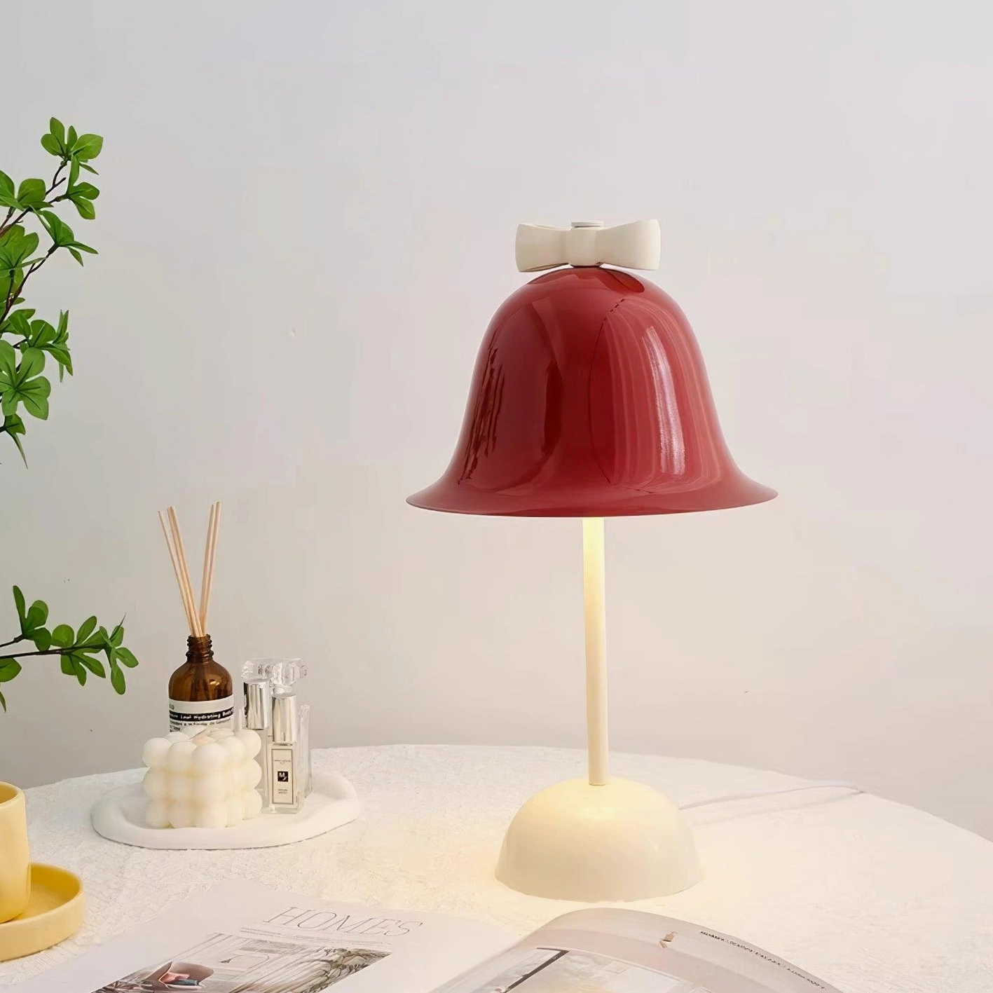 Contemporary red table lamp on decorative mat in dining room with candles and home decor accessories
