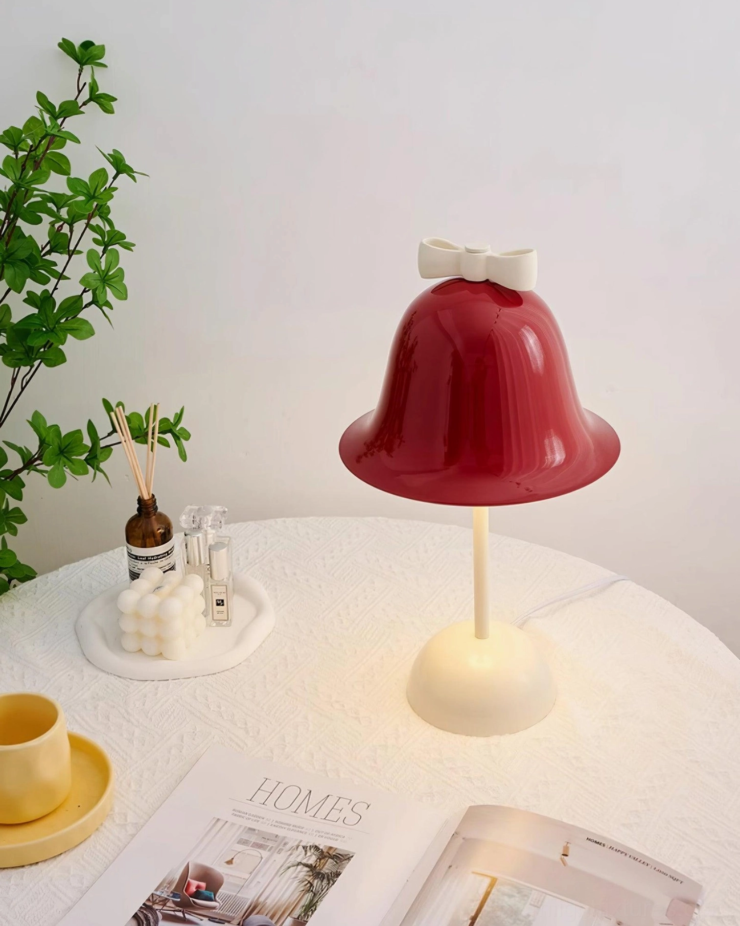 Compact table lamp with 23cm shade diameter on bedroom accent table with home accessories