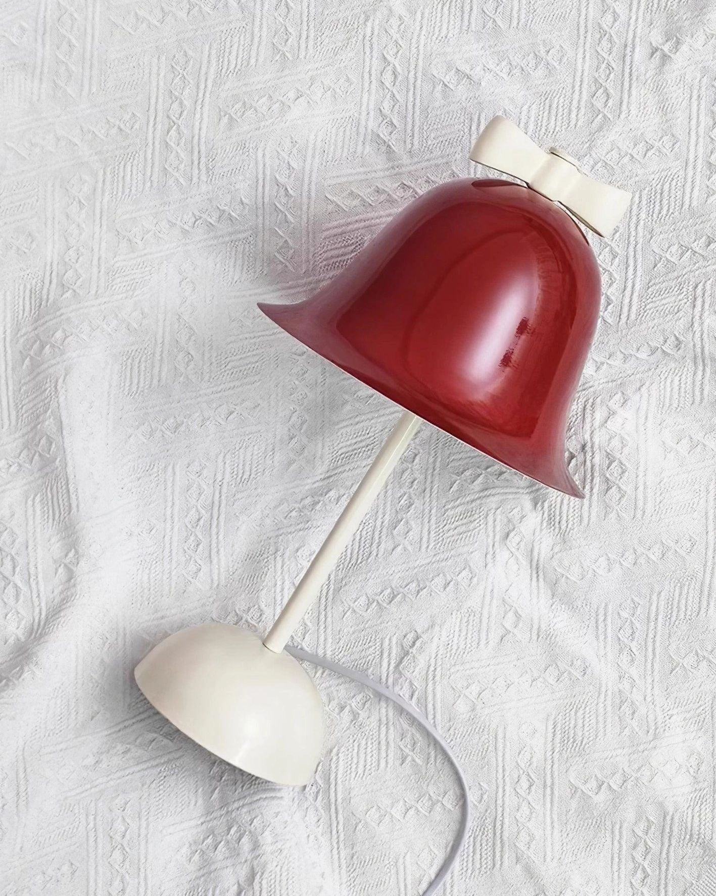 Modern table lamp on textured linen background showing three-color LED technology and power cord
