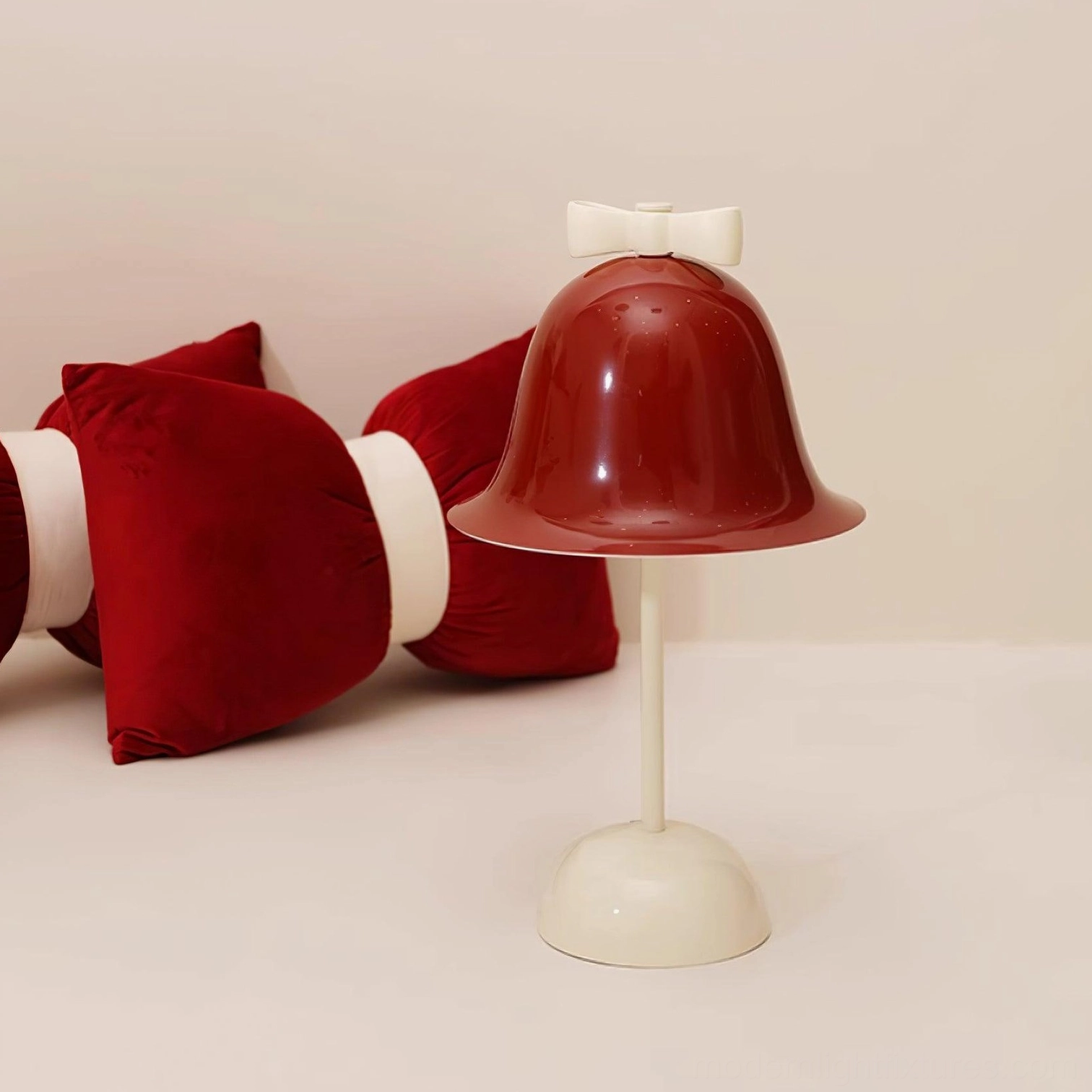 Red and white contemporary table lamp showing bow-knot silhouette and cream colored base