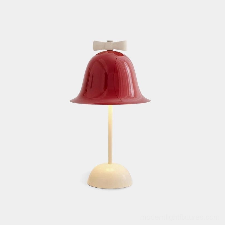 Modern bow-knot table lamp with wine red shade and cream base on white background, front view