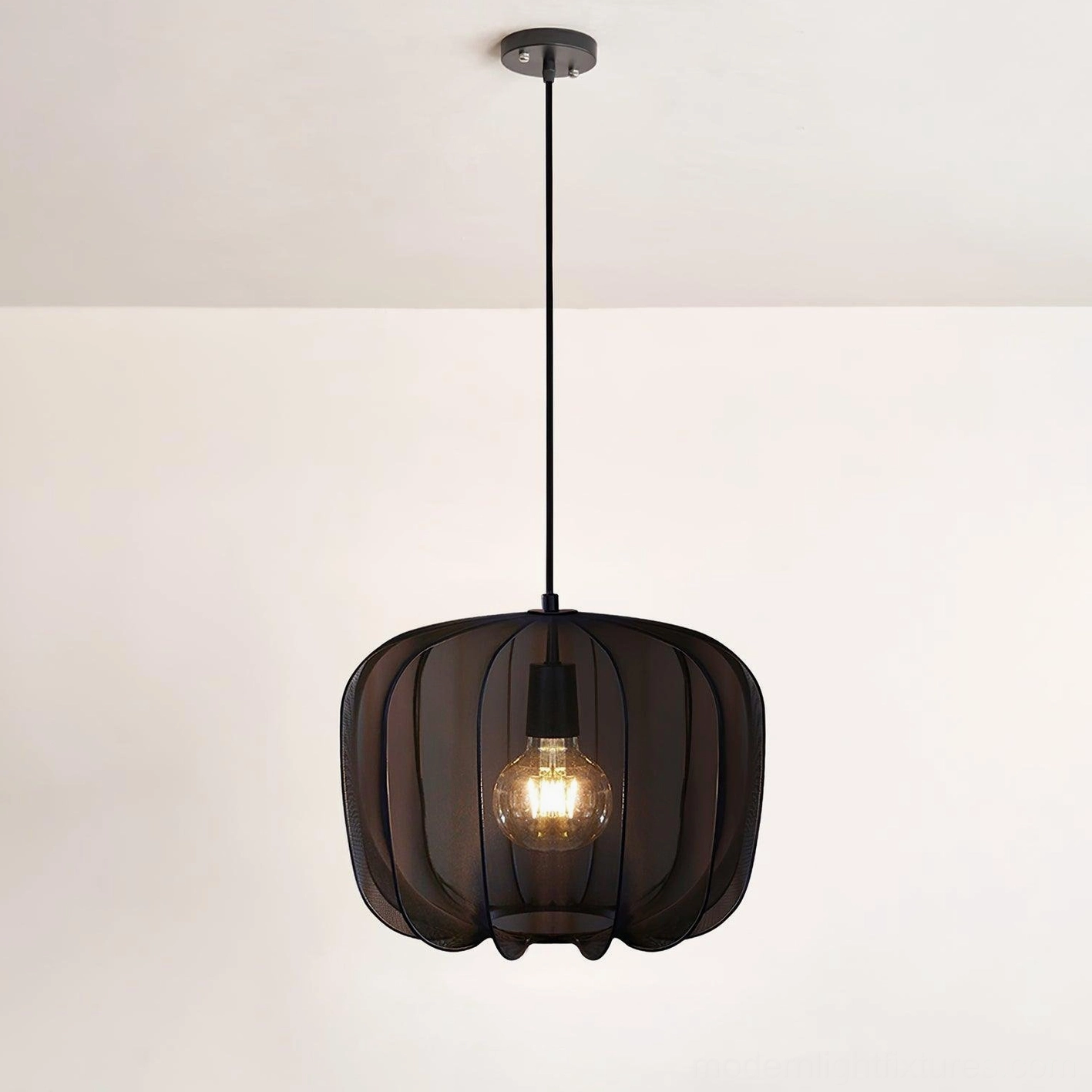 Black Nevola fabric pendant light installed in interior space, modern industrial pendant fixture