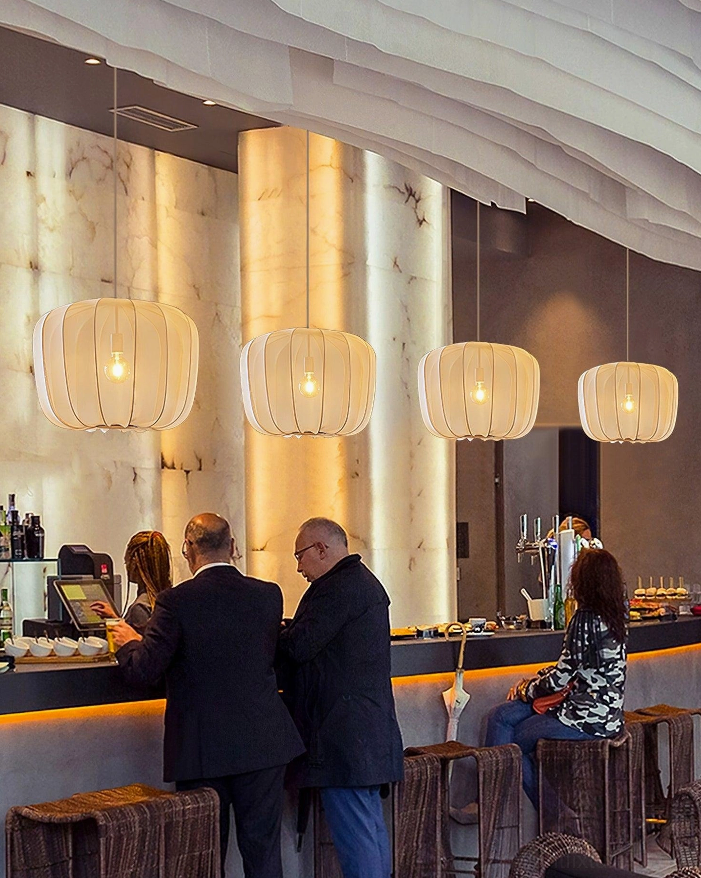 Beige fabric Nevola pendant lights in restaurant bar interior, commercial hospitality lighting installation